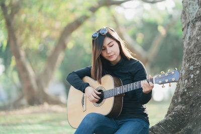 Young woman playing guitar