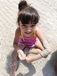 High angle view of girl playing on shore at beach