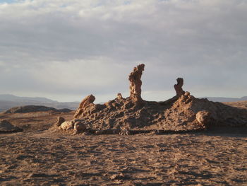 Rock formation on landscape against sky