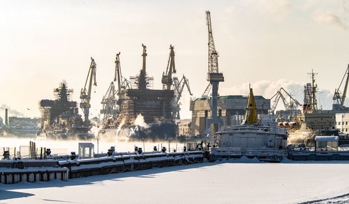 View of harbor against sky during winter