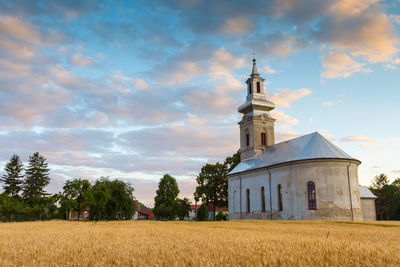 Rural landscape with wheat field and a church in turiec region.