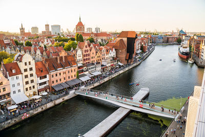 High angle view of bridge over river amidst buildings in city