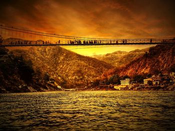 Bridge over river at sunset