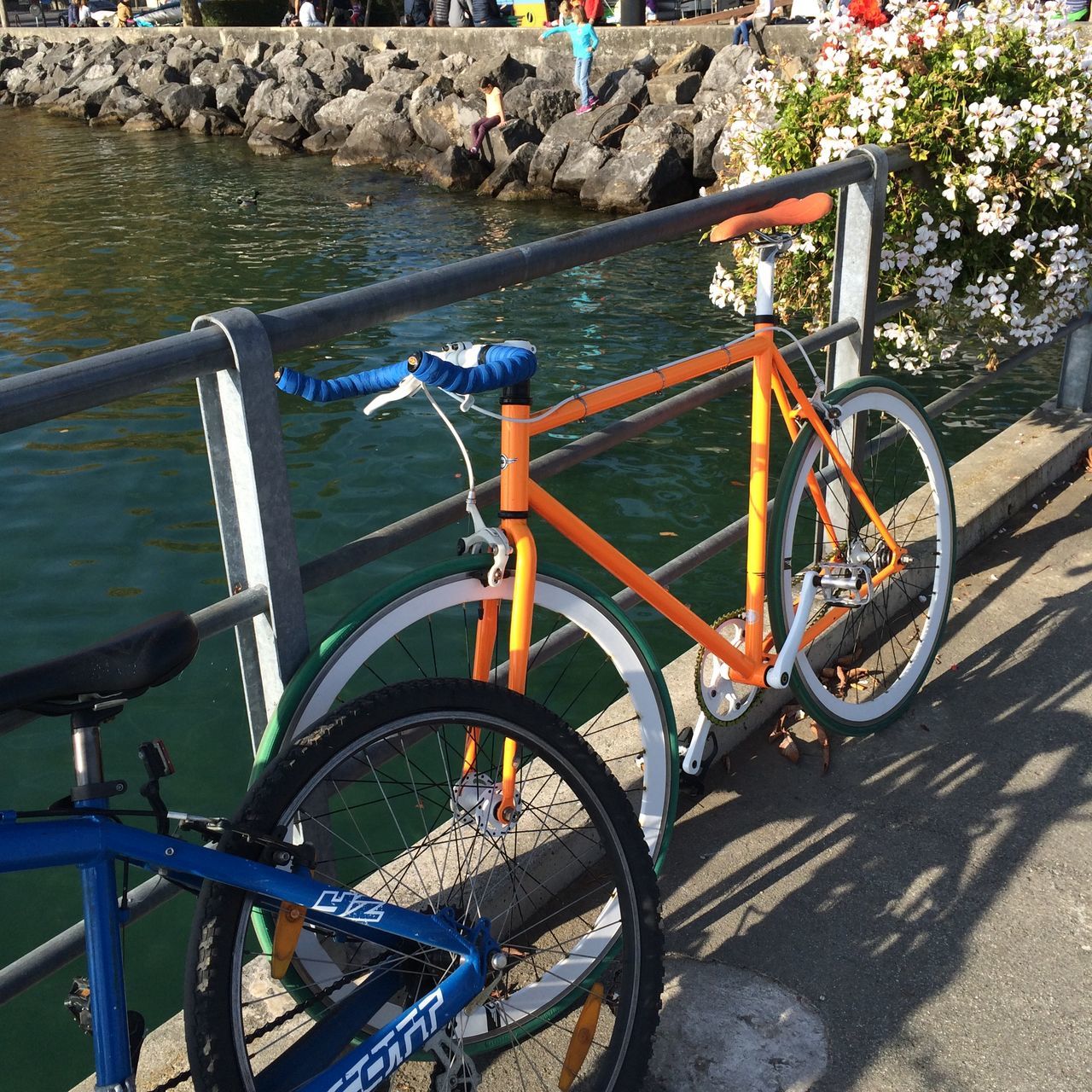 bicycle, transportation, mode of transport, land vehicle, stationary, wheel, parking, high angle view, parked, part of, outdoors, day, street, tire, sunlight, cropped, no people, travel, nature, water