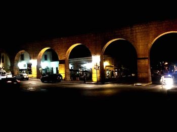 View of illuminated road at night