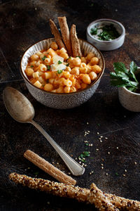 Directly above shot of pasta in container over cutting board