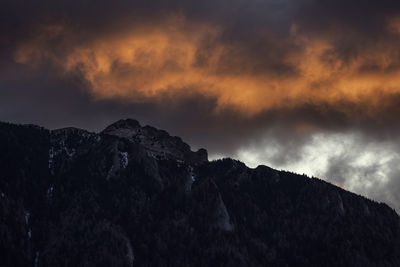 Low angle view of rocks against sky during sunset