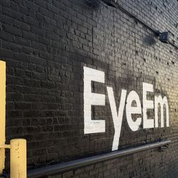 Low angle view of information sign on brick wall