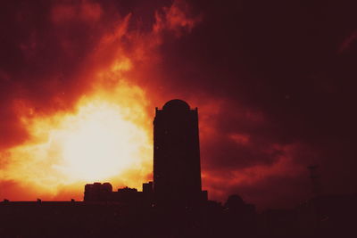 Silhouette of building against dramatic sky