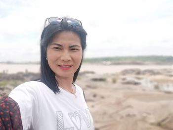 Portrait of smiling young woman on beach