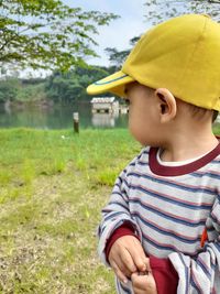 Baby boy looking at the lake