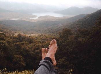 Low section of man relaxing on mountain