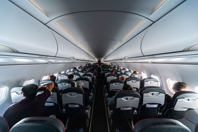 Rear view of people sitting in airplane