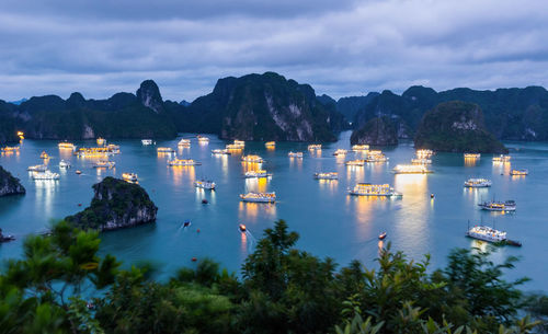 Scenic view of boats in sea against sky