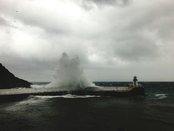 Scenic view of sea water splashing against sky