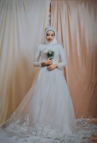 Woman standing on white wall