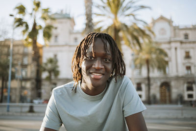 Portrait of a smiling young woman in city