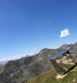 Scenic view of mountains against blue sky