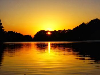 Scenic view of lake against romantic sky at sunset