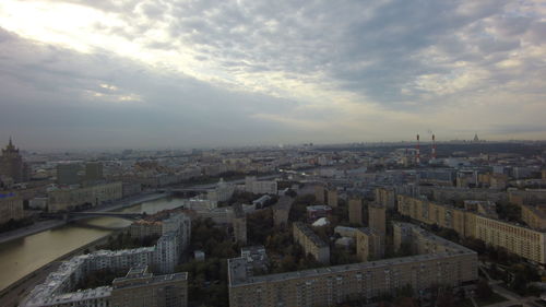 Cityscape against cloudy sky