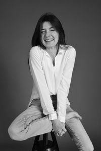 Portrait of a smiling young woman sitting outdoors