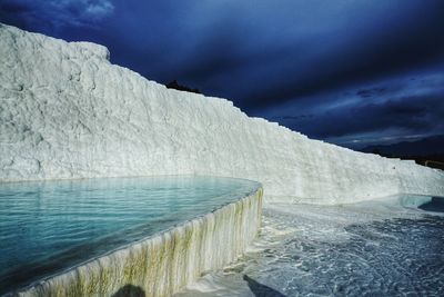 Scenic view of travertine terraces against sky