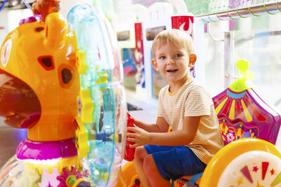 Portrait of boy playing with toys