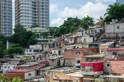 Residential buildings in city against sky