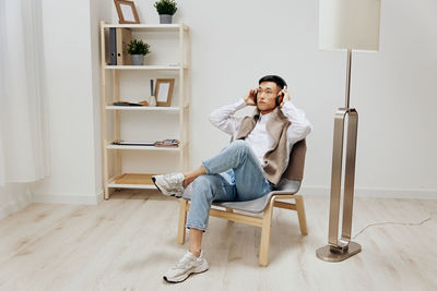 Portrait of woman sitting on sofa at home