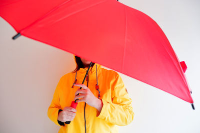 Midsection of person holding umbrella