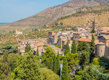 High angle view of trees and buildings in city