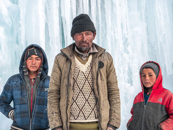 Portrait of friends standing in snow