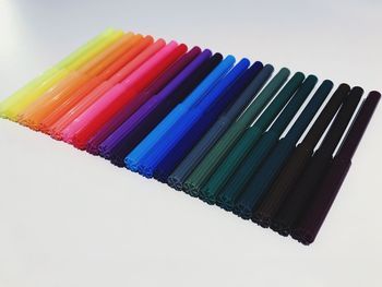 Close-up of multi colored pencils over white background