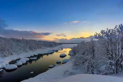 Winter sunset on the teriberka river in russia's kola peninsula