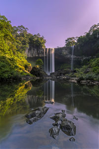 Scenic view of waterfall against sky