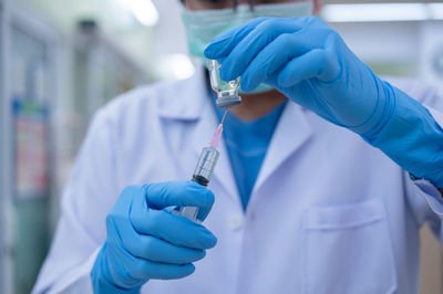 Midsection of person holding umbrella