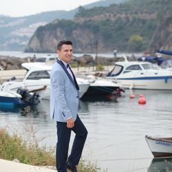 Portrait of man standing by lake