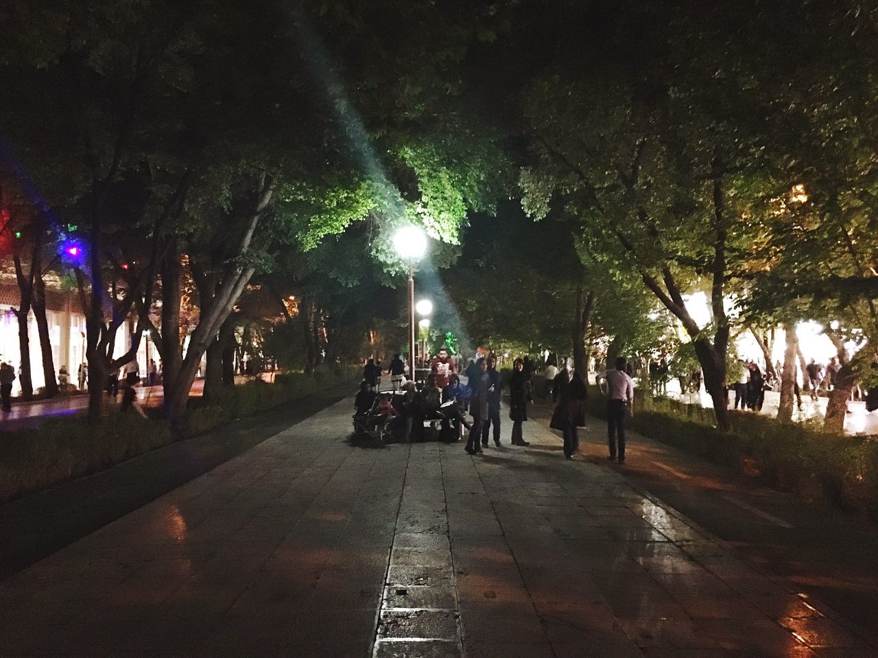 PEOPLE WALKING ON STREET AT NIGHT