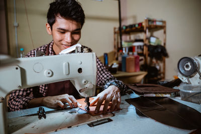 Side view of man working in workshop