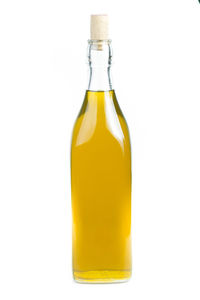 Close-up of yellow glass bottle against white background