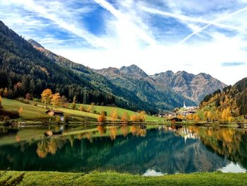 Scenic view of lake and mountains against sky