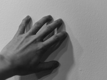 Close-up of human hand on wall