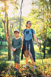 Full length of mother and daughter standing on tree