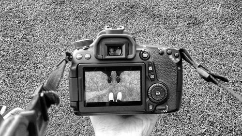 Cropped image of woman photographing through smart phone