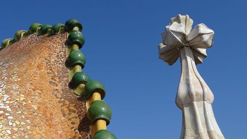 Low angle view of statue against blue sky