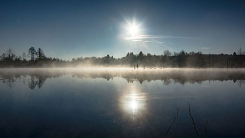 Scenic view of lake against sky during sunrise