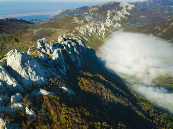 Dabarski kukovi rocks with the mist in the valley on the velebit mountain, croatia