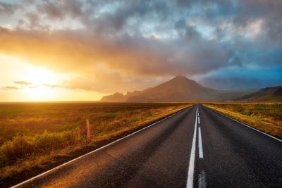 Road amidst landscape against sky during sunset