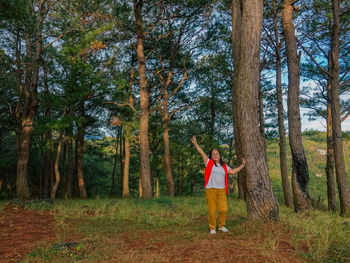 Me on a mountain , trees, enjoying the environment .