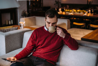 Man sitting on sofa at home